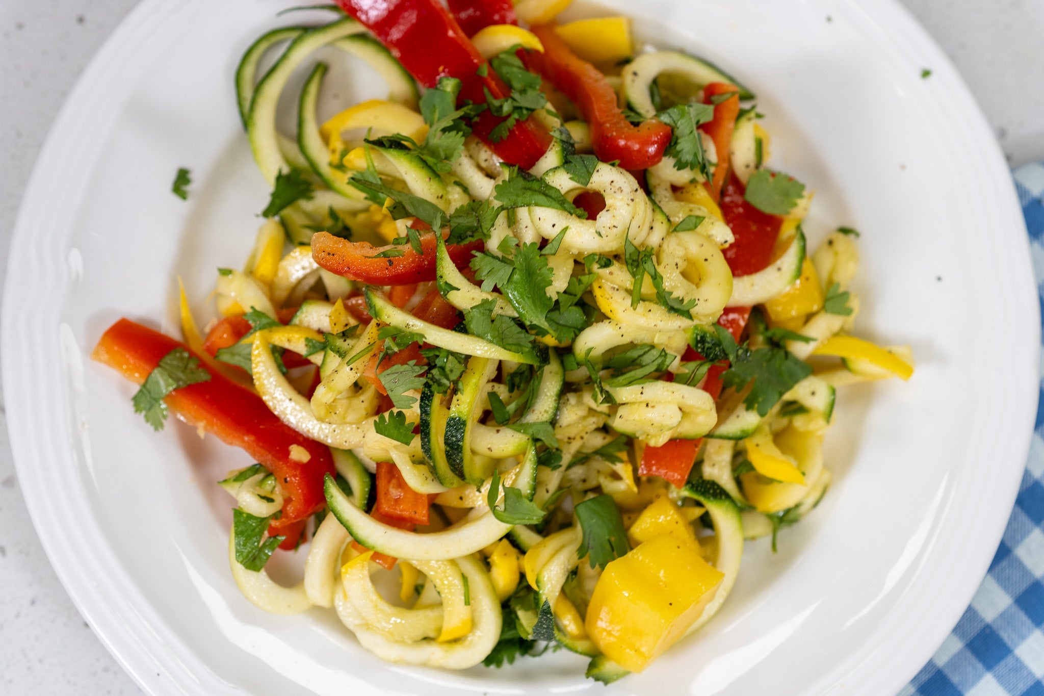Colorful, crisp, and packed with fresh flavor, this salad pairs spiralized zucchini and squash with sweet mango and a zingy citrus-ginger vinaigrette. It's a summer must-make—quick, vibrant, and powered by Bosch.
