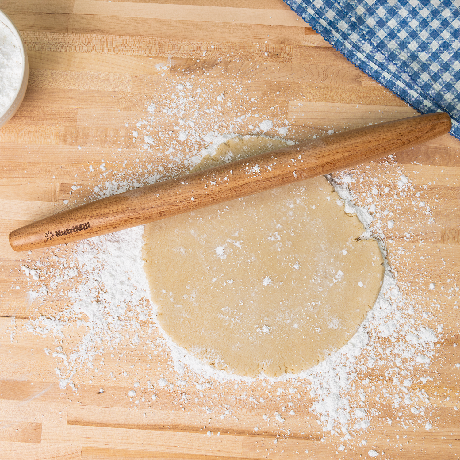 french beechwood nutrimill rolling pin rolling out dough on a floured counter top