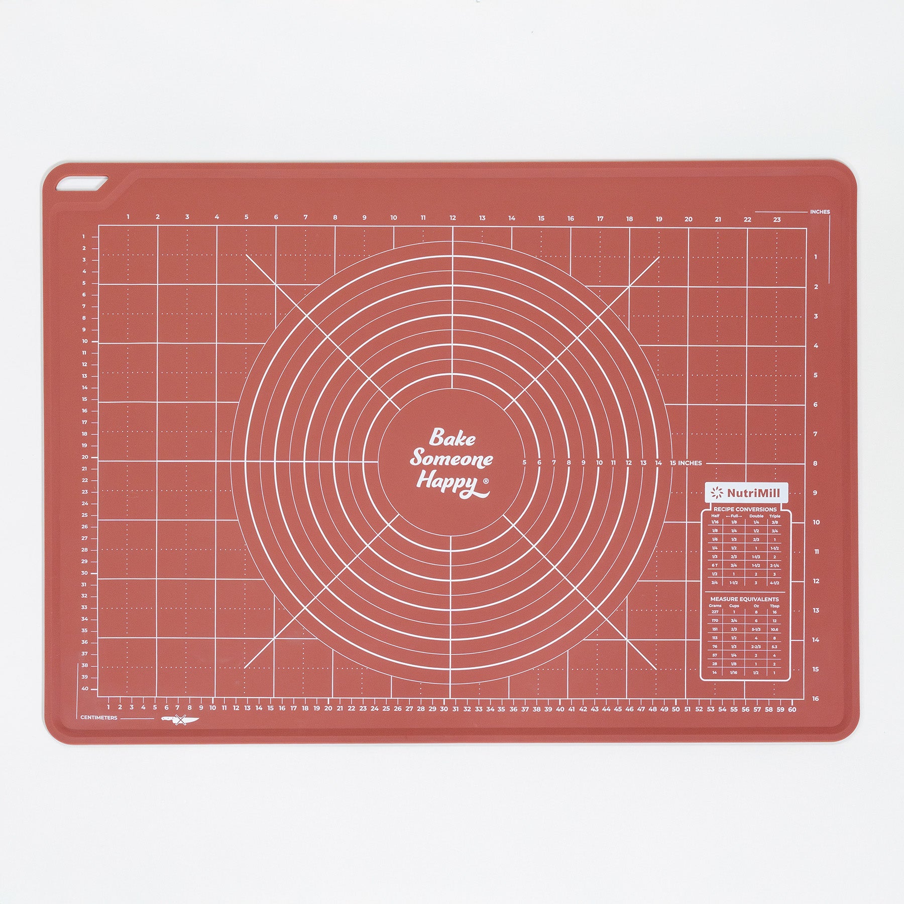 Red baking mat with grid lines and 'Bake Someone Happy' text on a white background