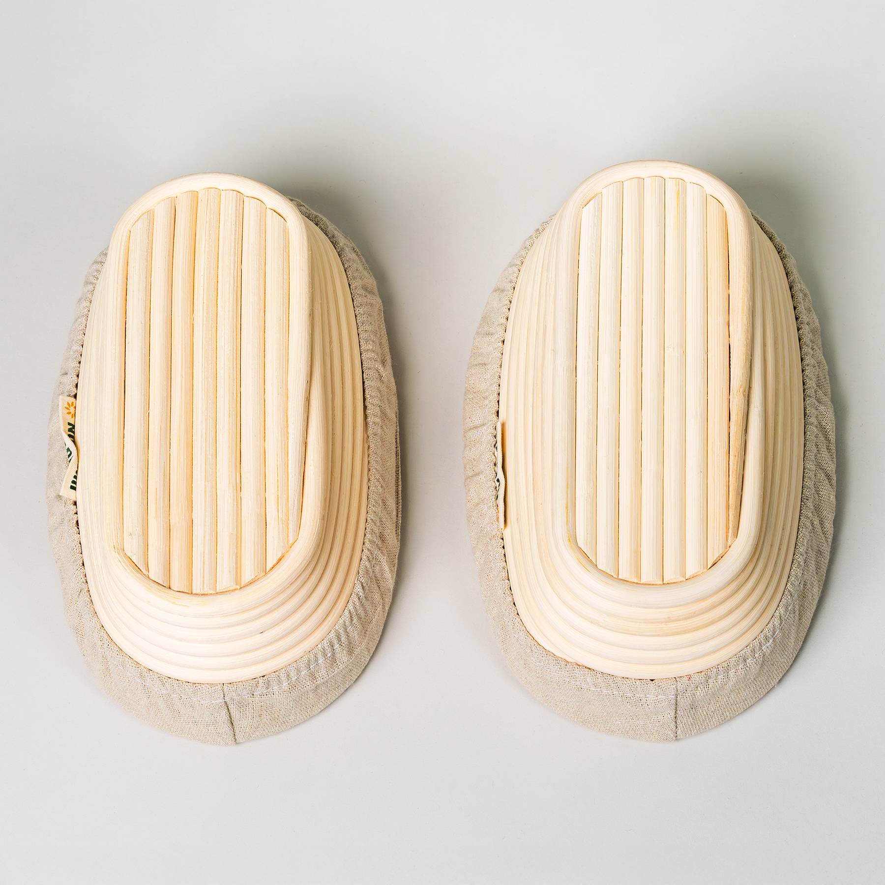 2 NutriMill banneton baskets upside down on a grey background