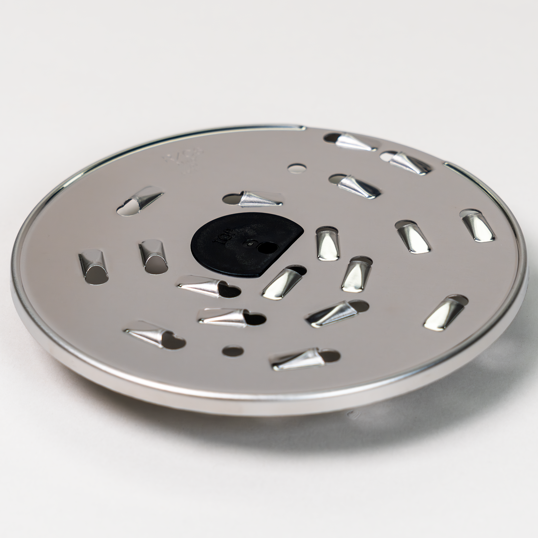 Magimix 6mm shredding disk on a grey background