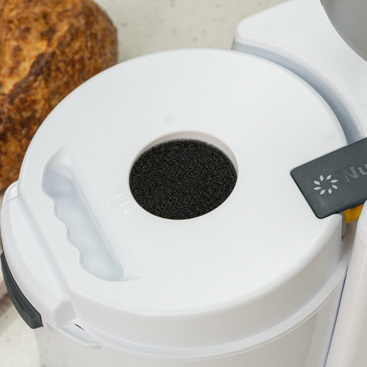 Close up of black filter on nutrimill impact grain mill