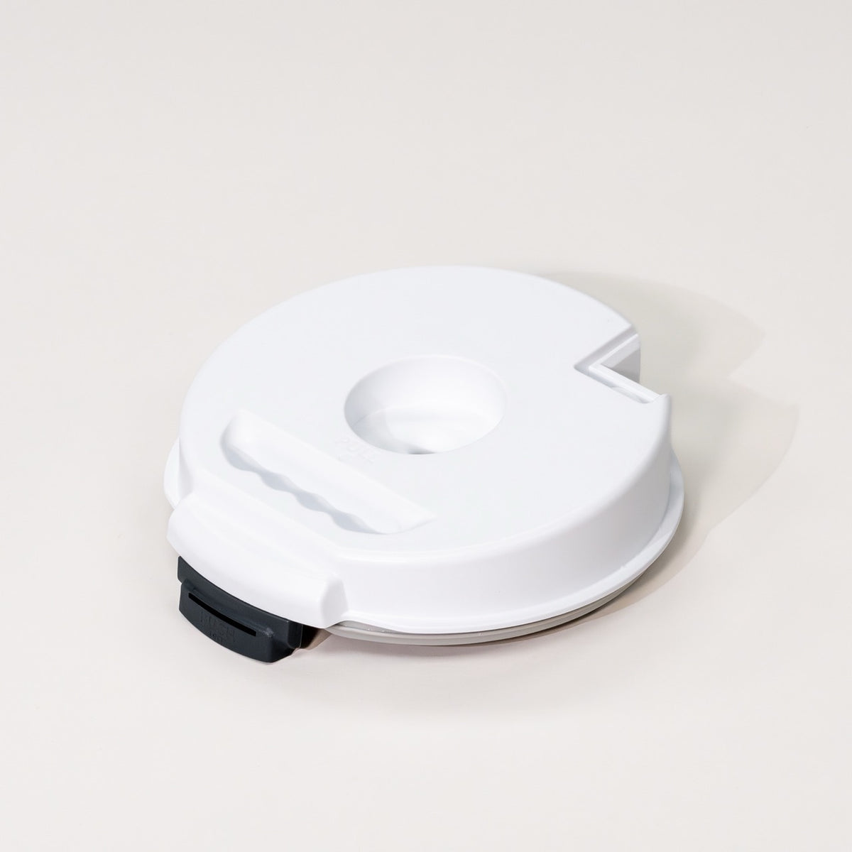 NutriMill Impact Grain Mill canister lid on grey background