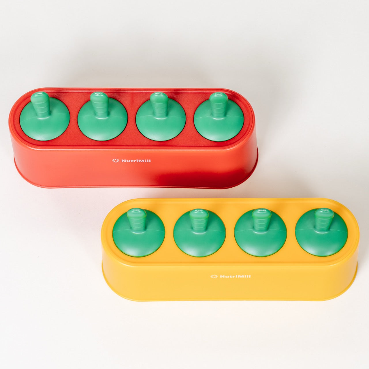 Two colorful popsicle molds with green handles on a white background