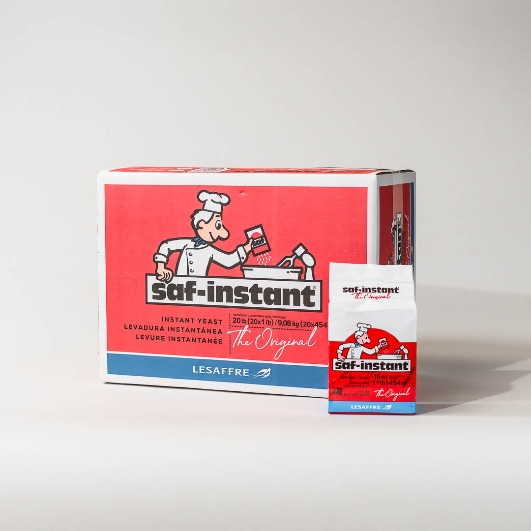 A case of 20 SAF Red Label Instant Yeast with a cartoon baker on the front, indicating it is a product for baking.