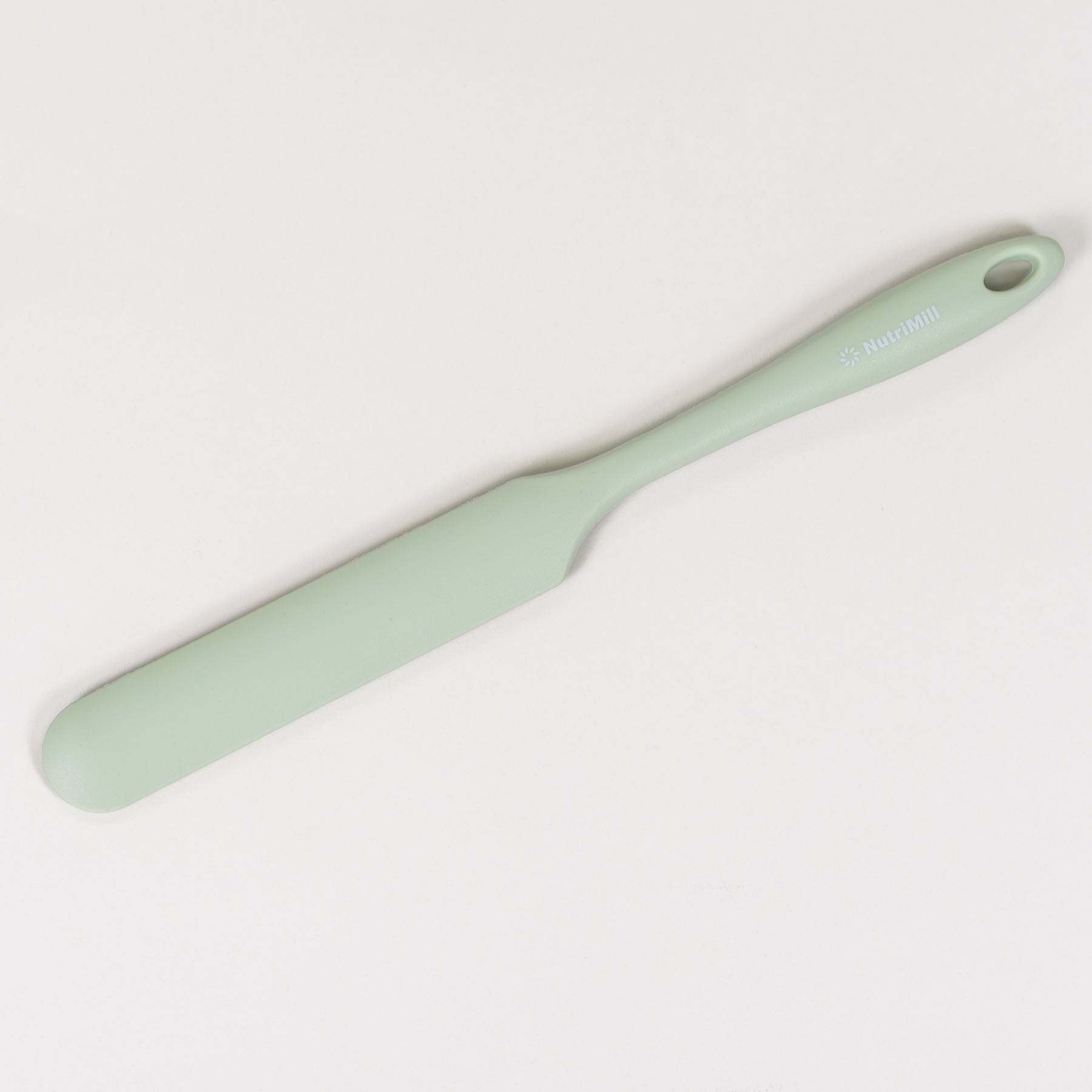 Mint green spatula on a white background