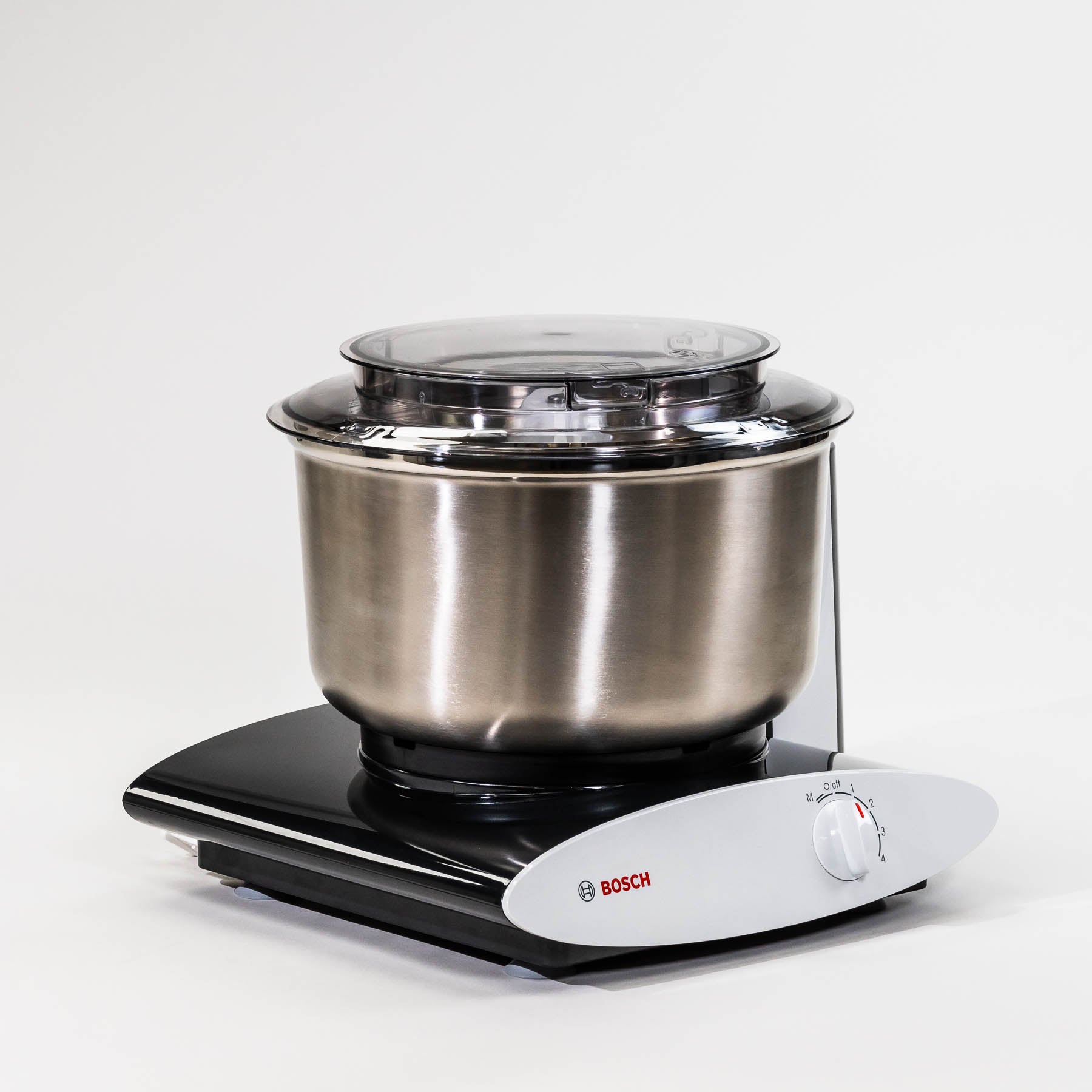 A black Bosch universal plus mixer with a stainless steel bowl on a grey background