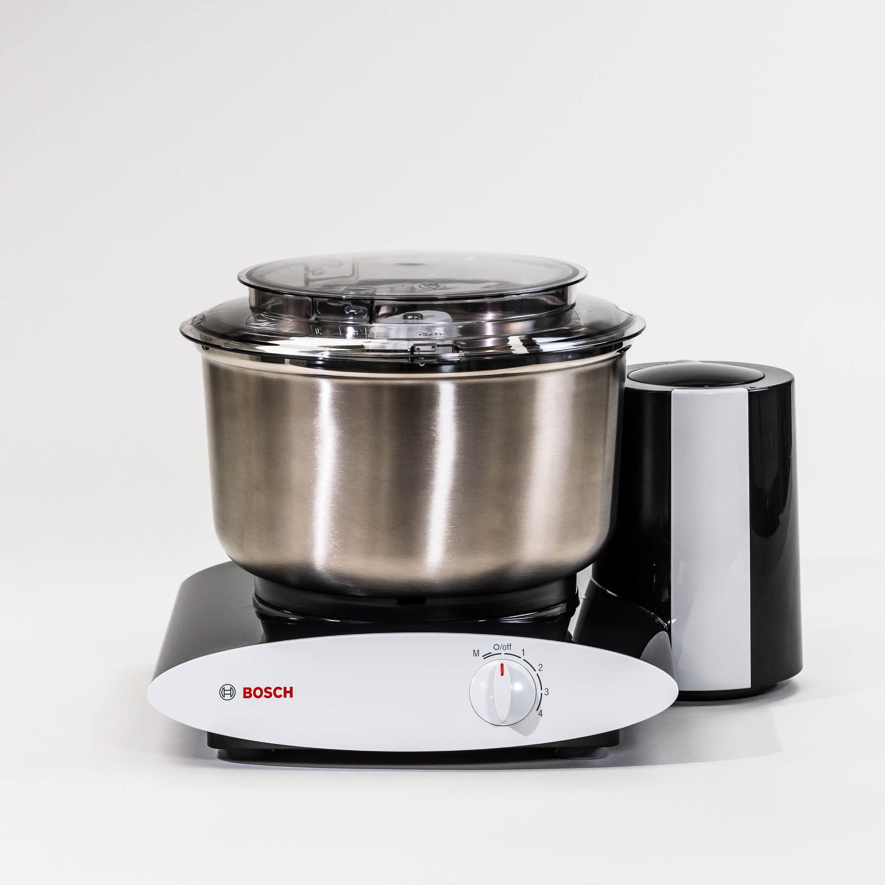 A black Bosch stand mixer with a stainless steel bowl, control knob on the front, and suction feet.