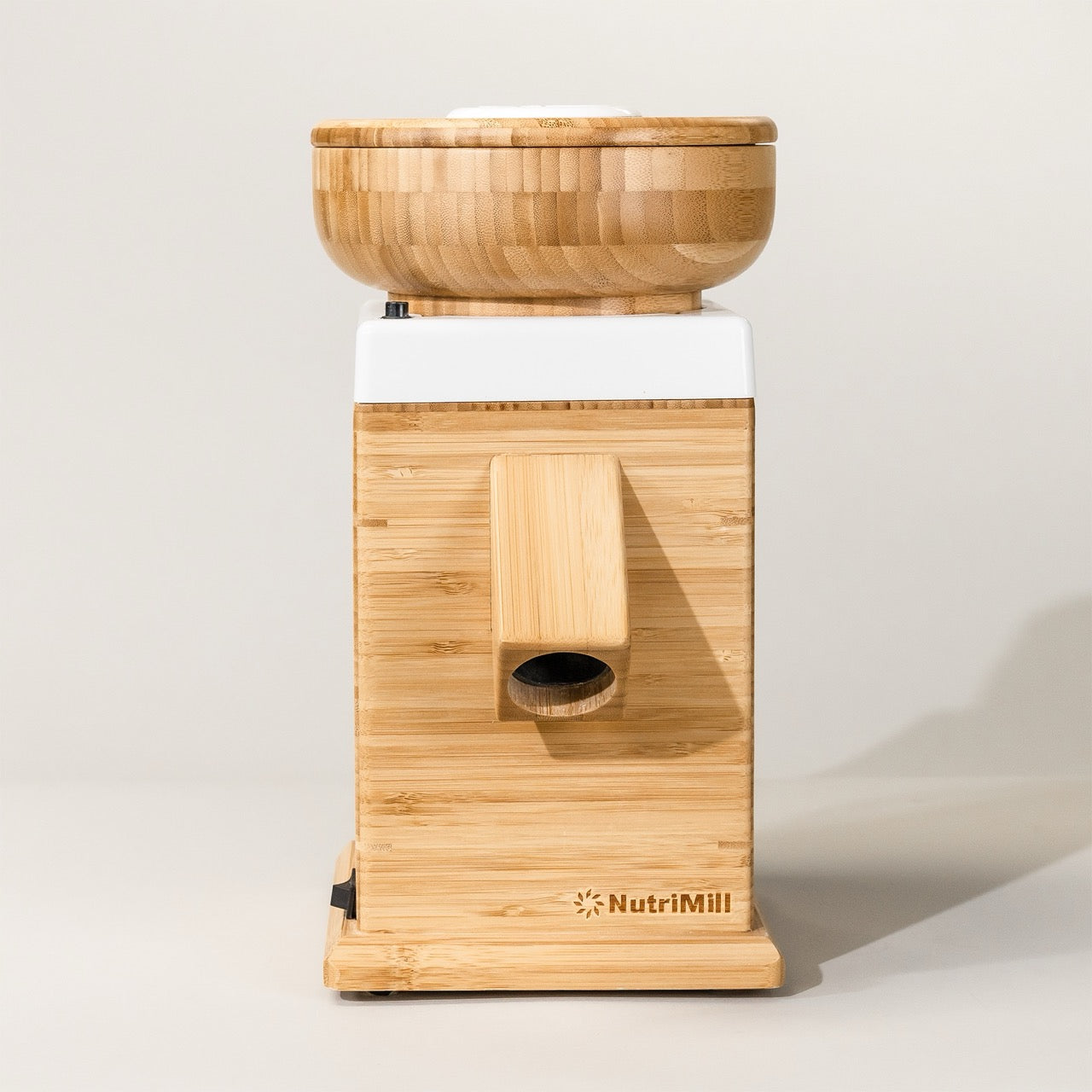A NutriMill Harvest grain mill in white color with bamboo housing and a corundum milling stone.