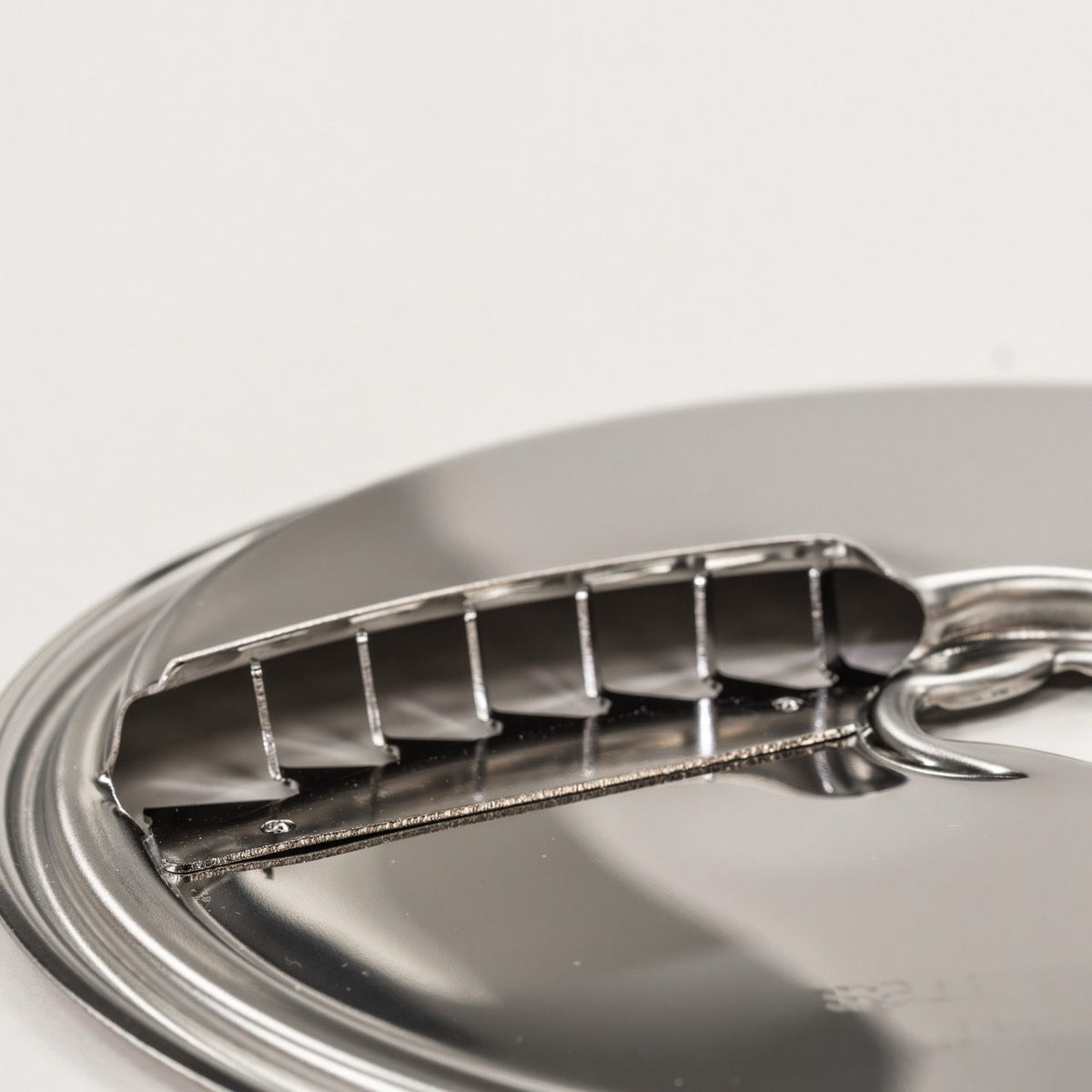 Close-up of the stainless steel French Fry Disk blade for the NutriMill Large Slicer Shredder