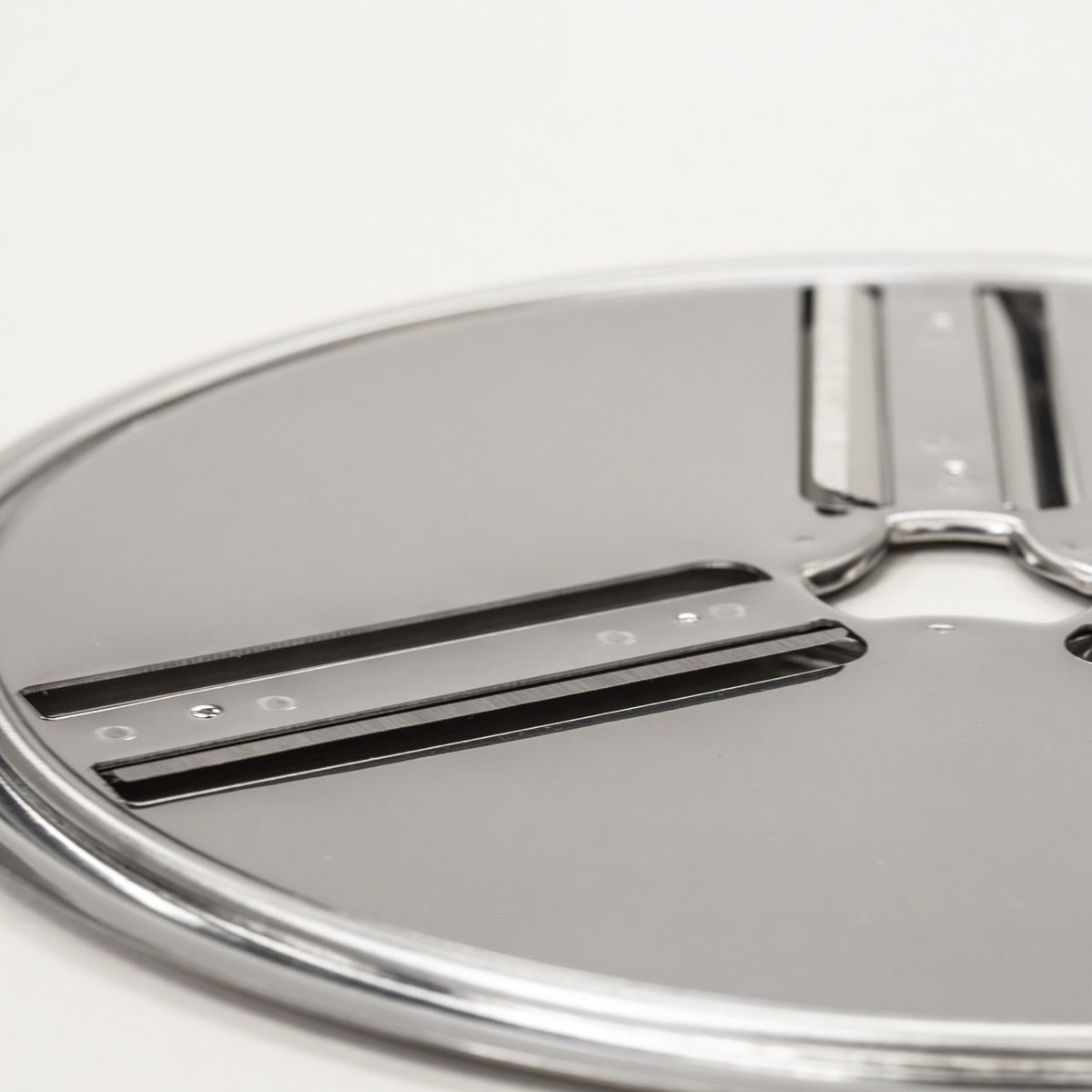 Close-up of the reversible slicing disk with its two stainless steel blades