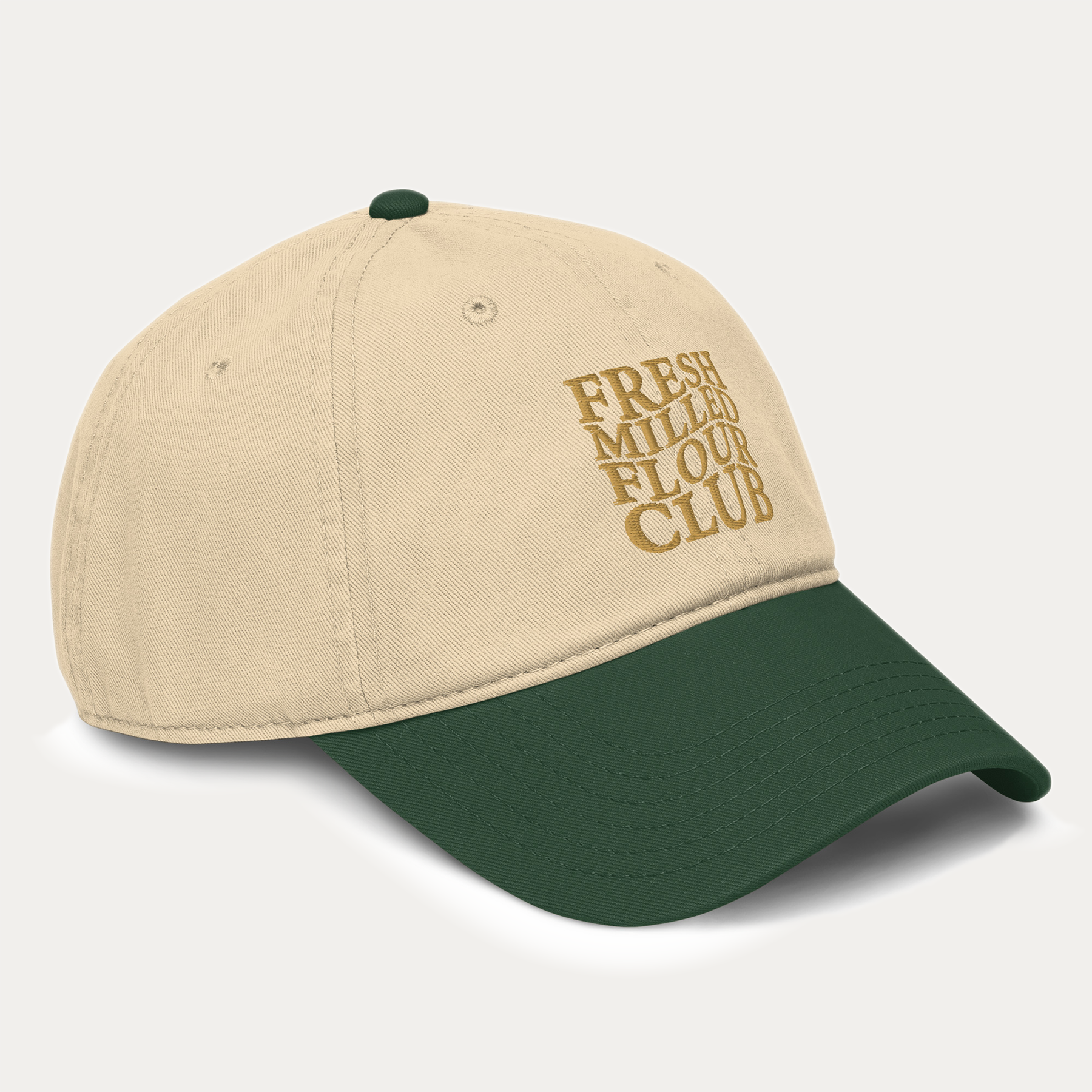 NutriMill beige and green cap with 'Fresh Milled Flour Club' text on a light gray background