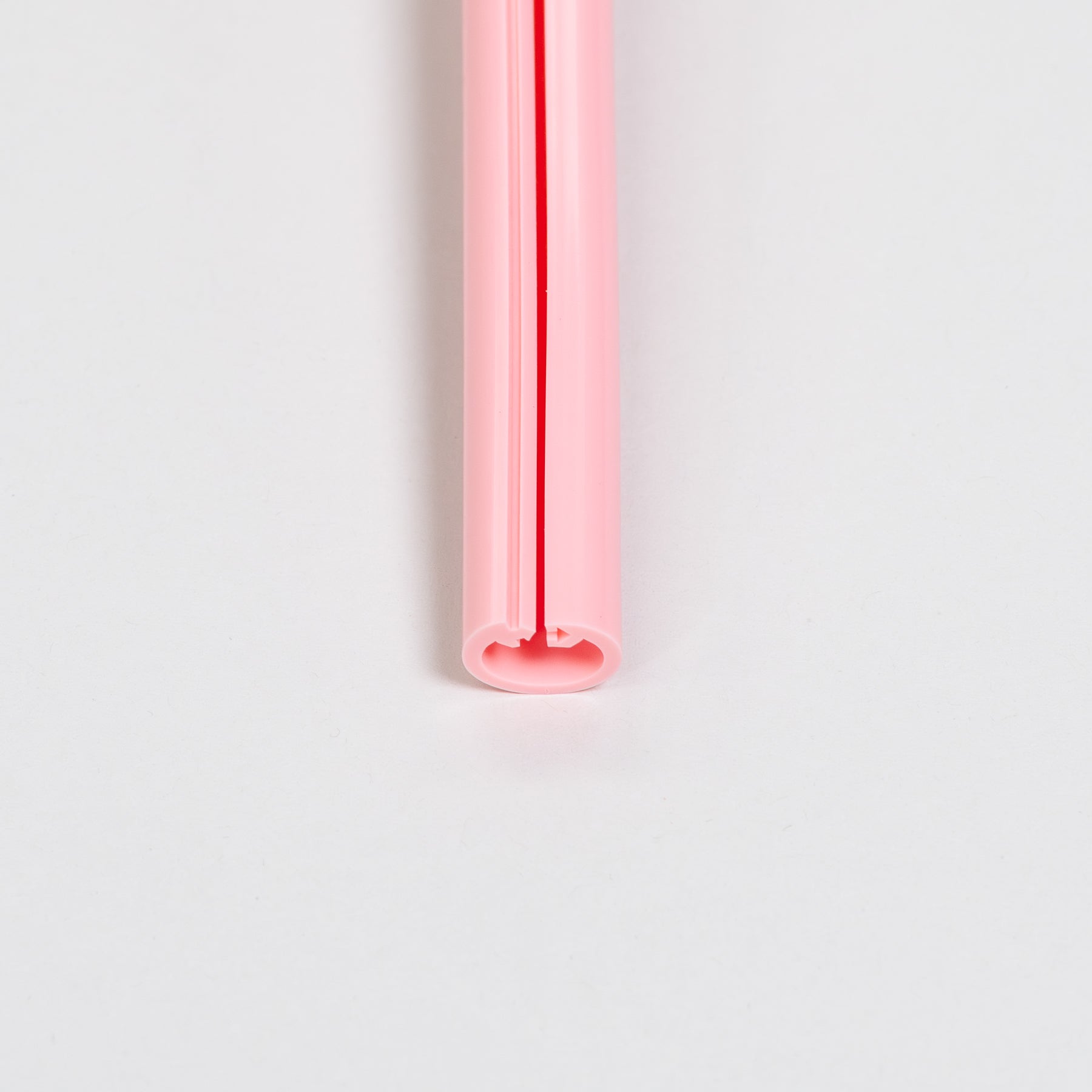 Pink straw on a white background