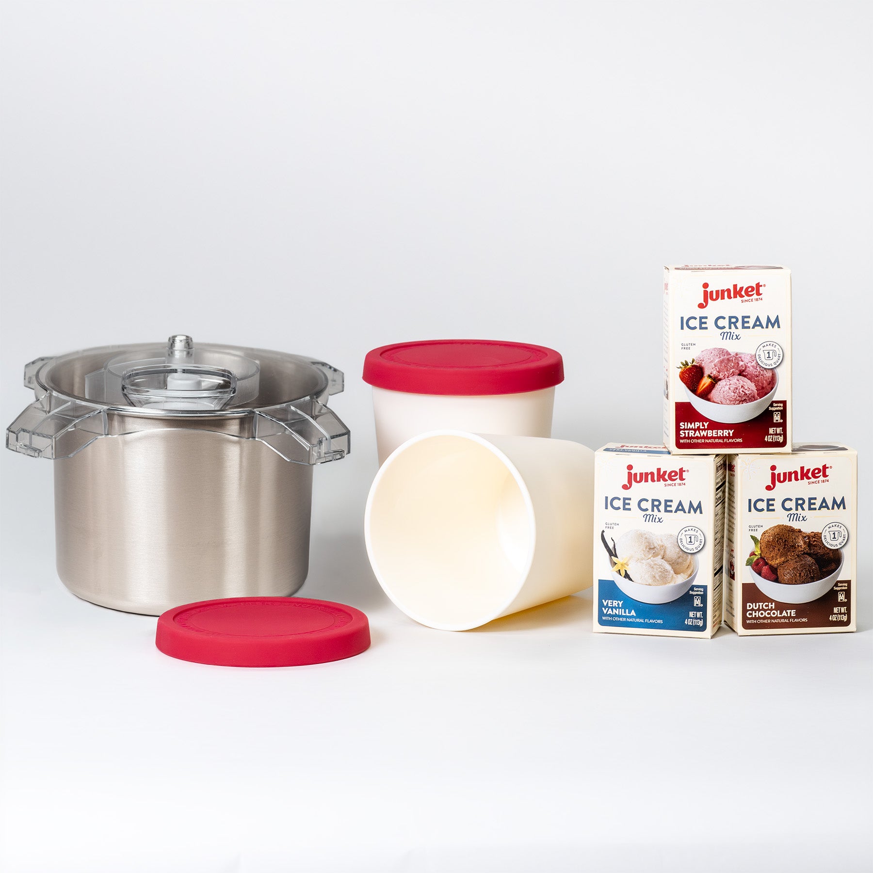 Stainless steel electric ice cream maker with pink lids beside boxes of ice cream mix on a white background