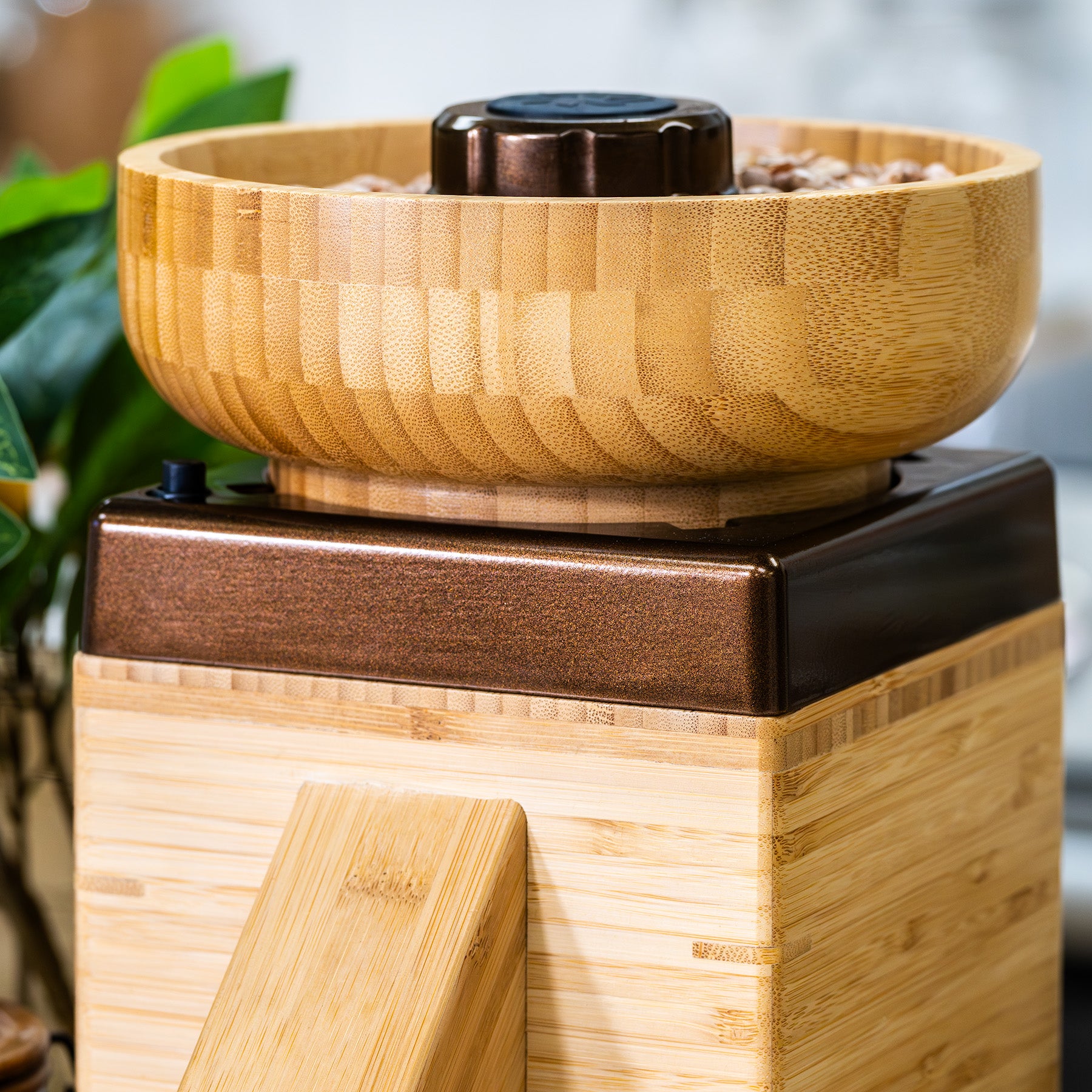 Up close view of the NutriMill harvest grain mill with bronze trim