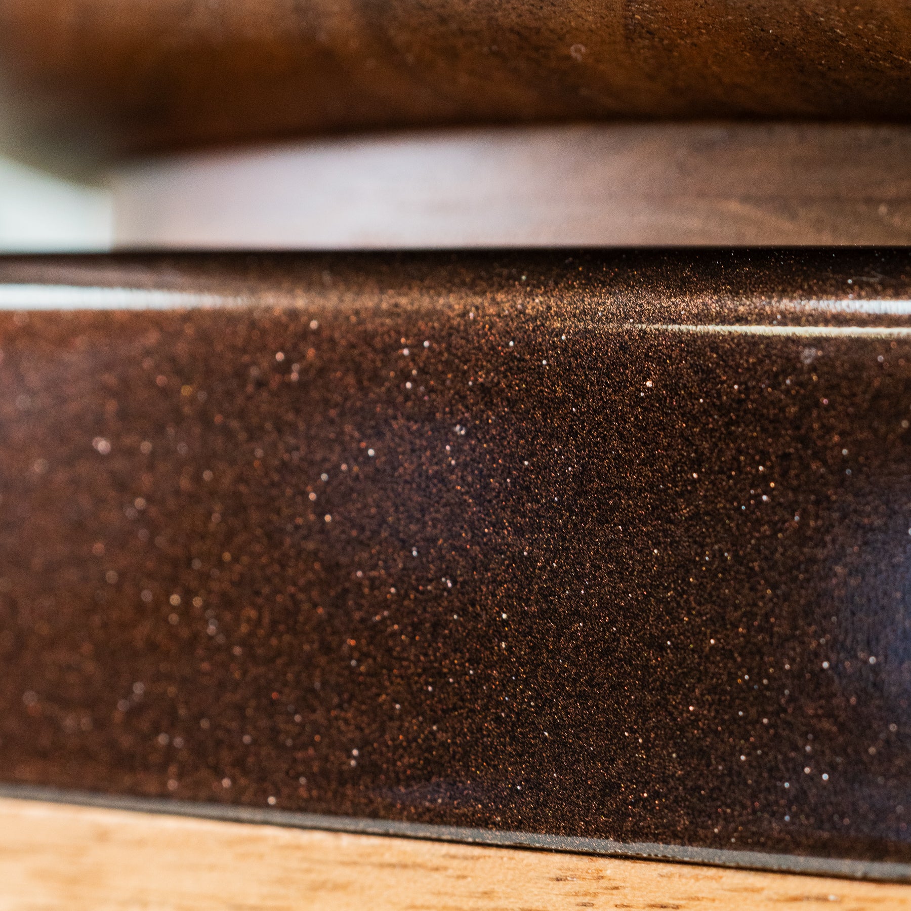 Close up of cocoa-colored trim of NutriMill harvest walnut grain mill