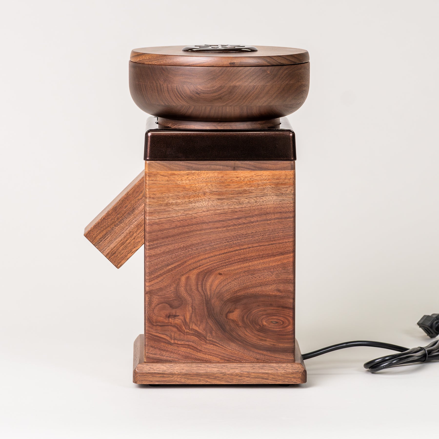 Side angle of NutriMill harvest walnut grain mill with cocoa-colored trim on grey background
