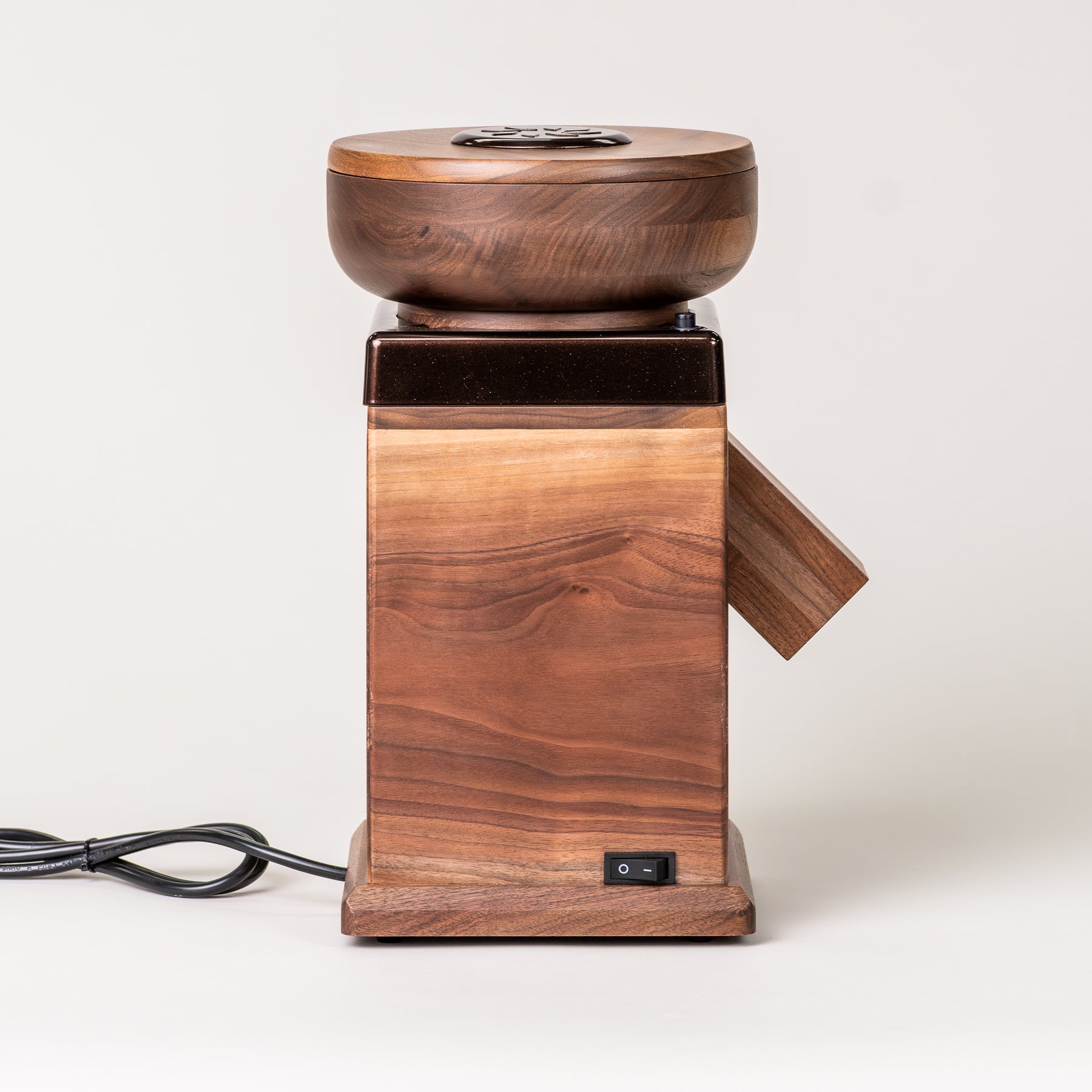 Side angle of NutriMill harvest walnut grain mill with cocoa-colored trim on grey background