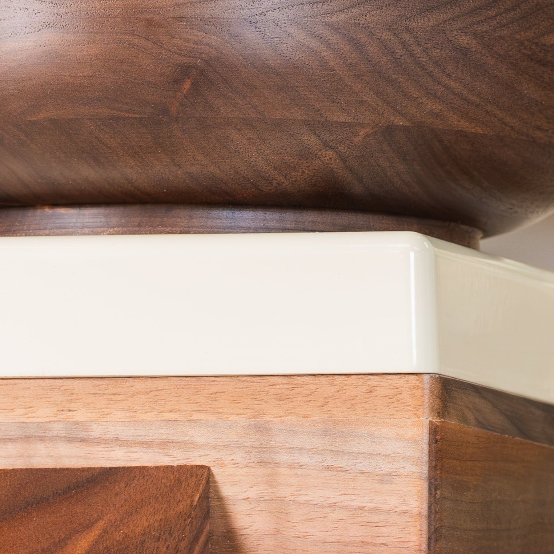 Close up of cream-colored trim on NutriMill harvest walnut grain mill