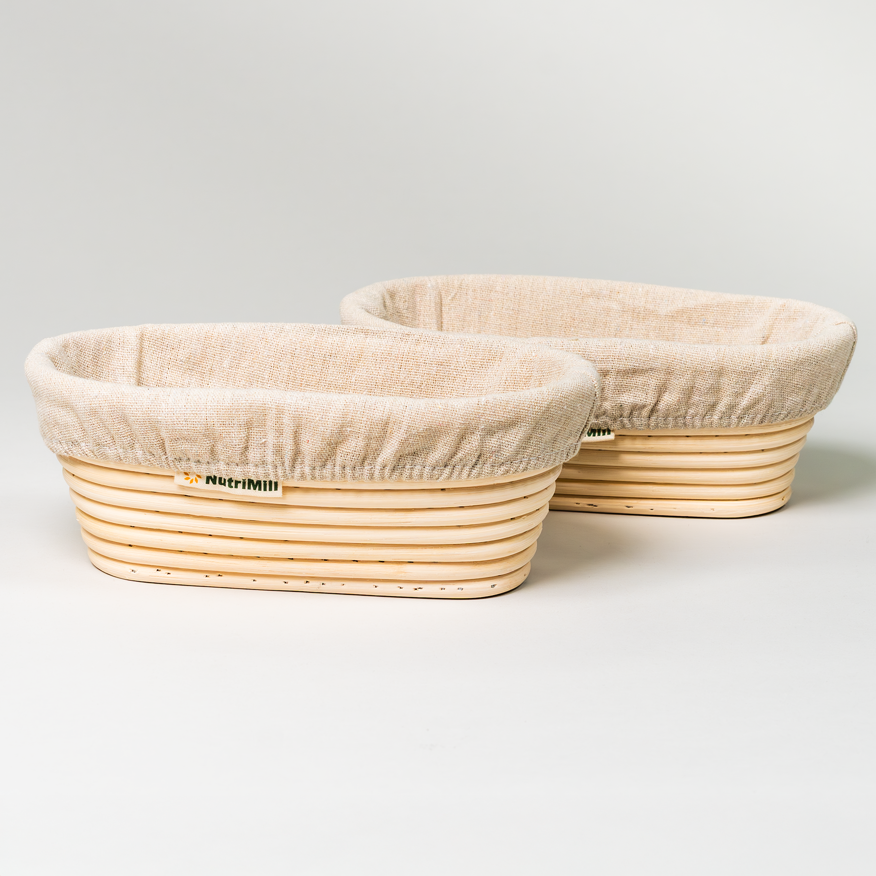 2 NutriMill banneton baskets on a grey background