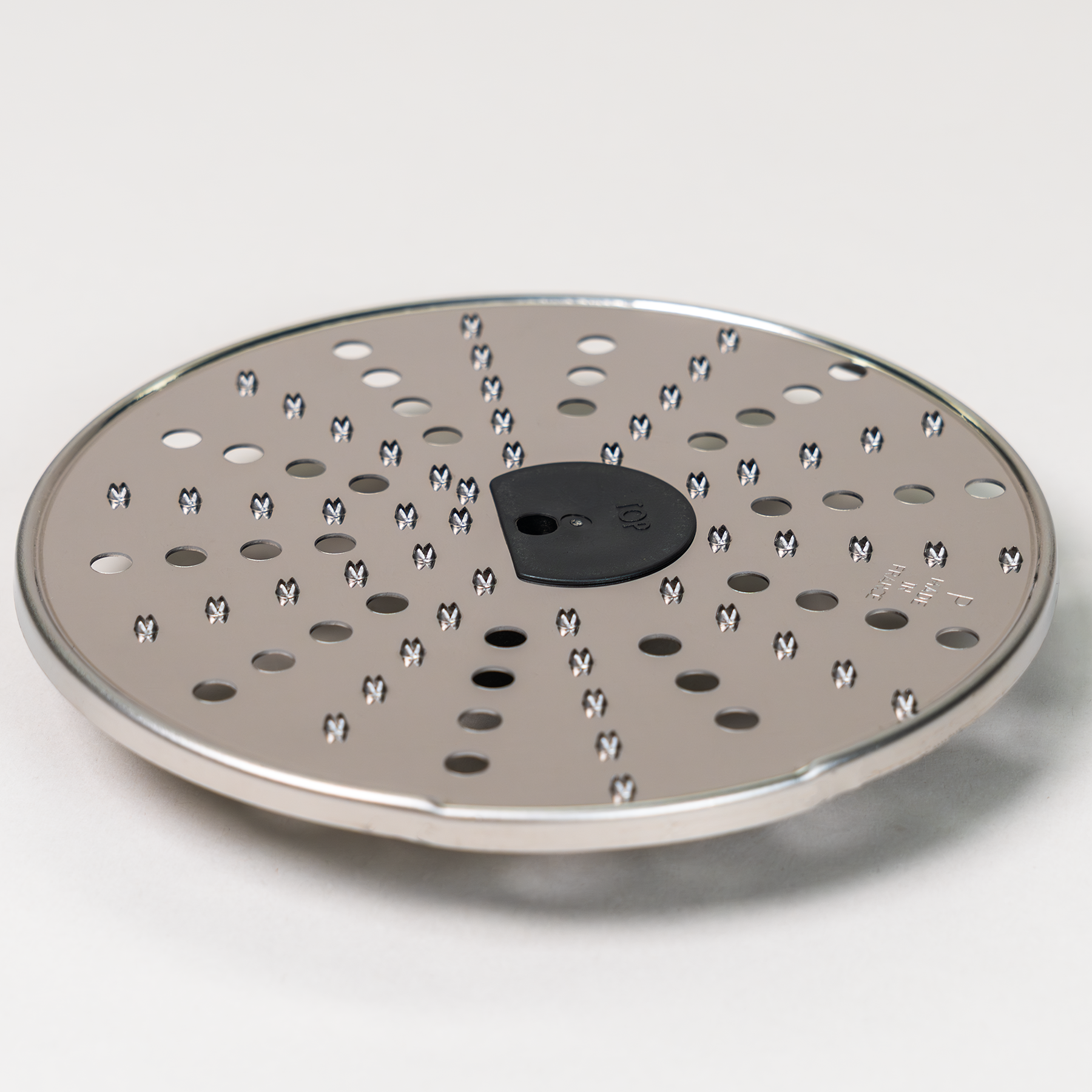 Magimix parmesan disk on a grey background