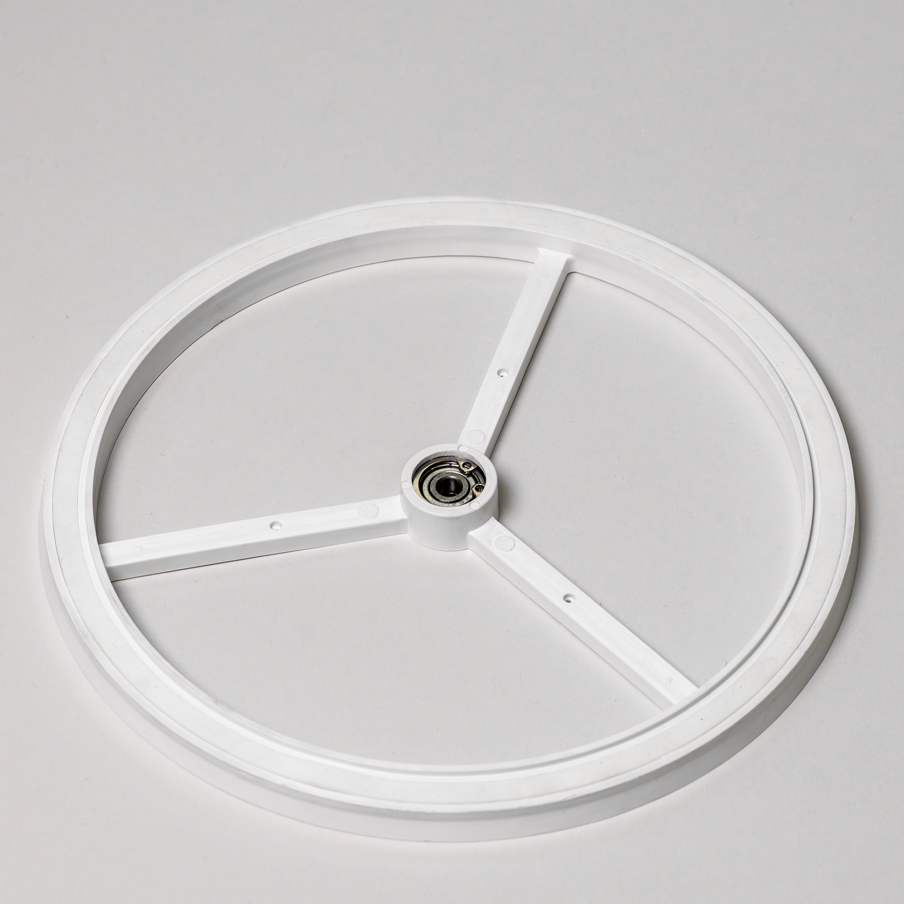 Screen housing of a flour sifter attachment on a grey background