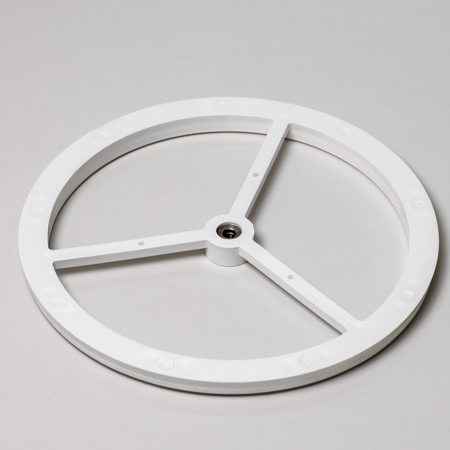 Screen housing of a flour sifter attachment on a grey background