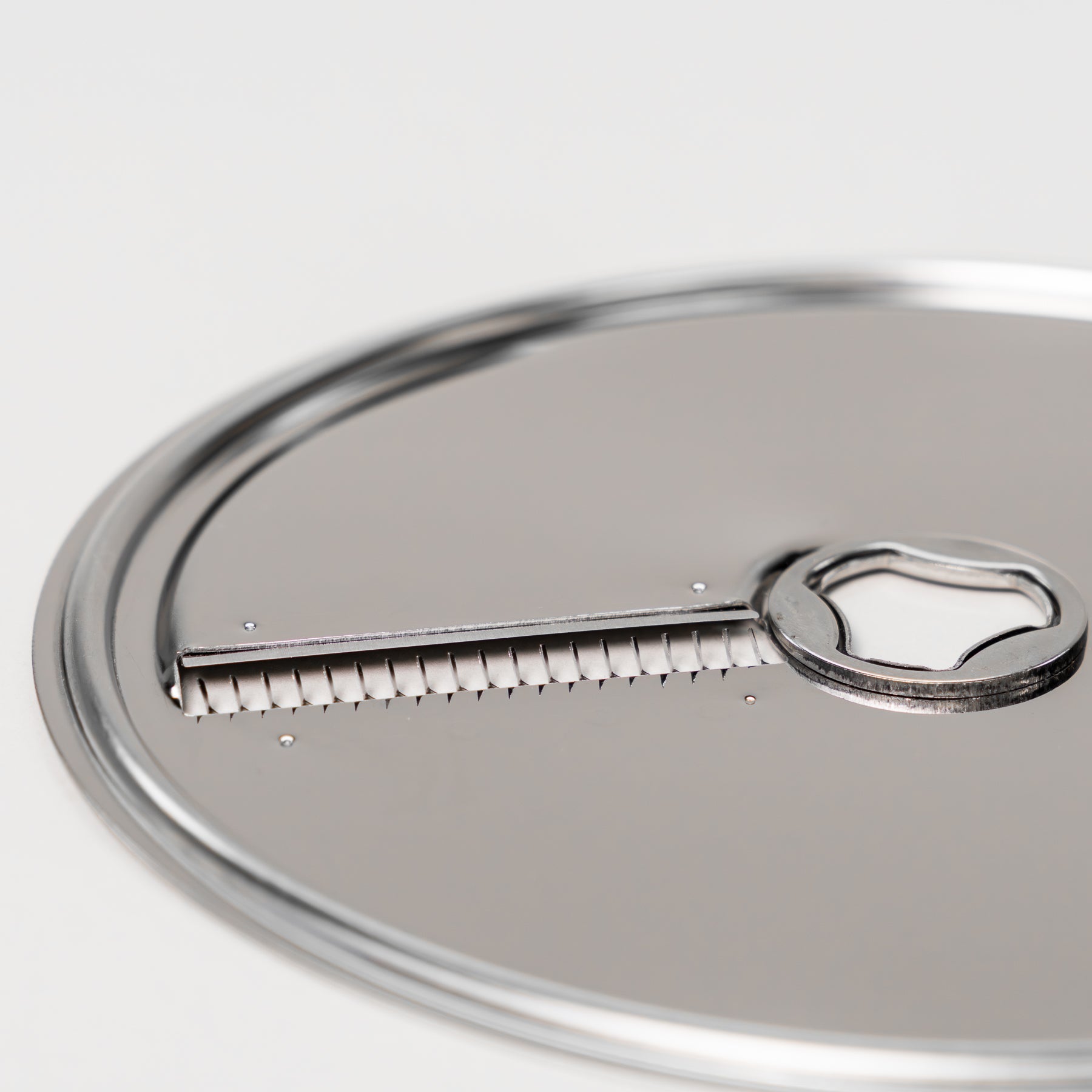 Close-up of the cutting blade on a stainless steel julienne disk for the NutriMill large slicer shredder attachment