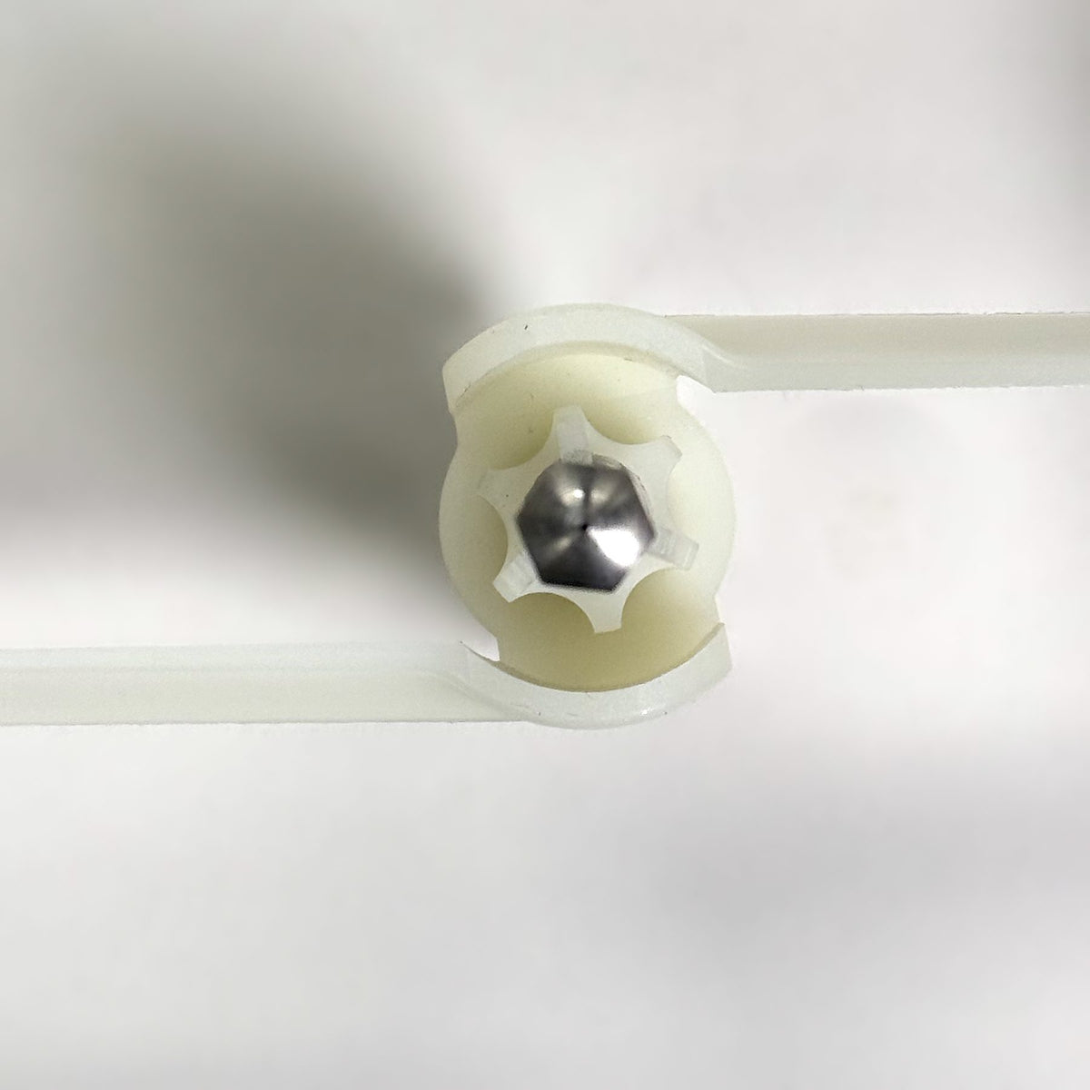 Close-up of the Bosch Compact slicer shredder slinger hub showing the star-shaped drive end and hex shaft tip