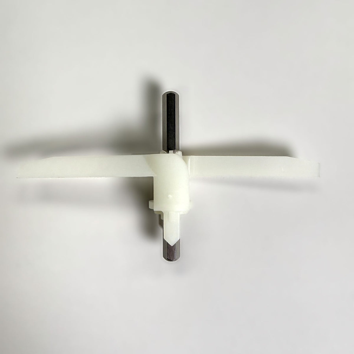 Front view of the Bosch Compact slicer shredder slinger showing both blades and the steel drive shaft, on a grey background