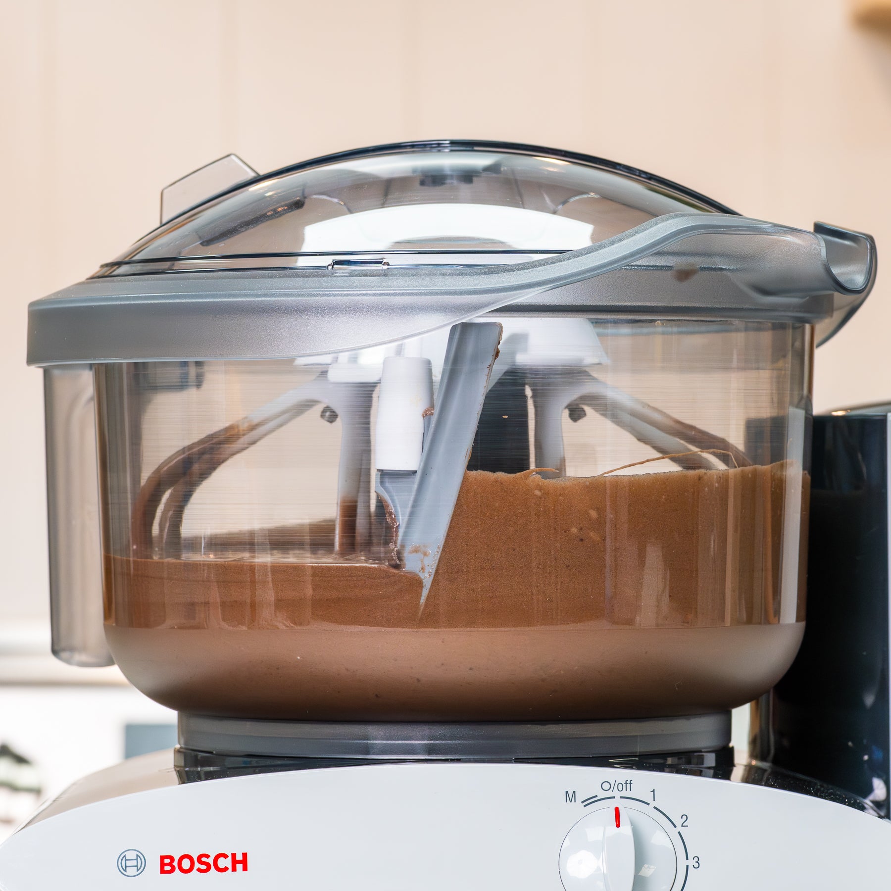 Clear bowl with brown batter inside attached to bosch universal plus mixer