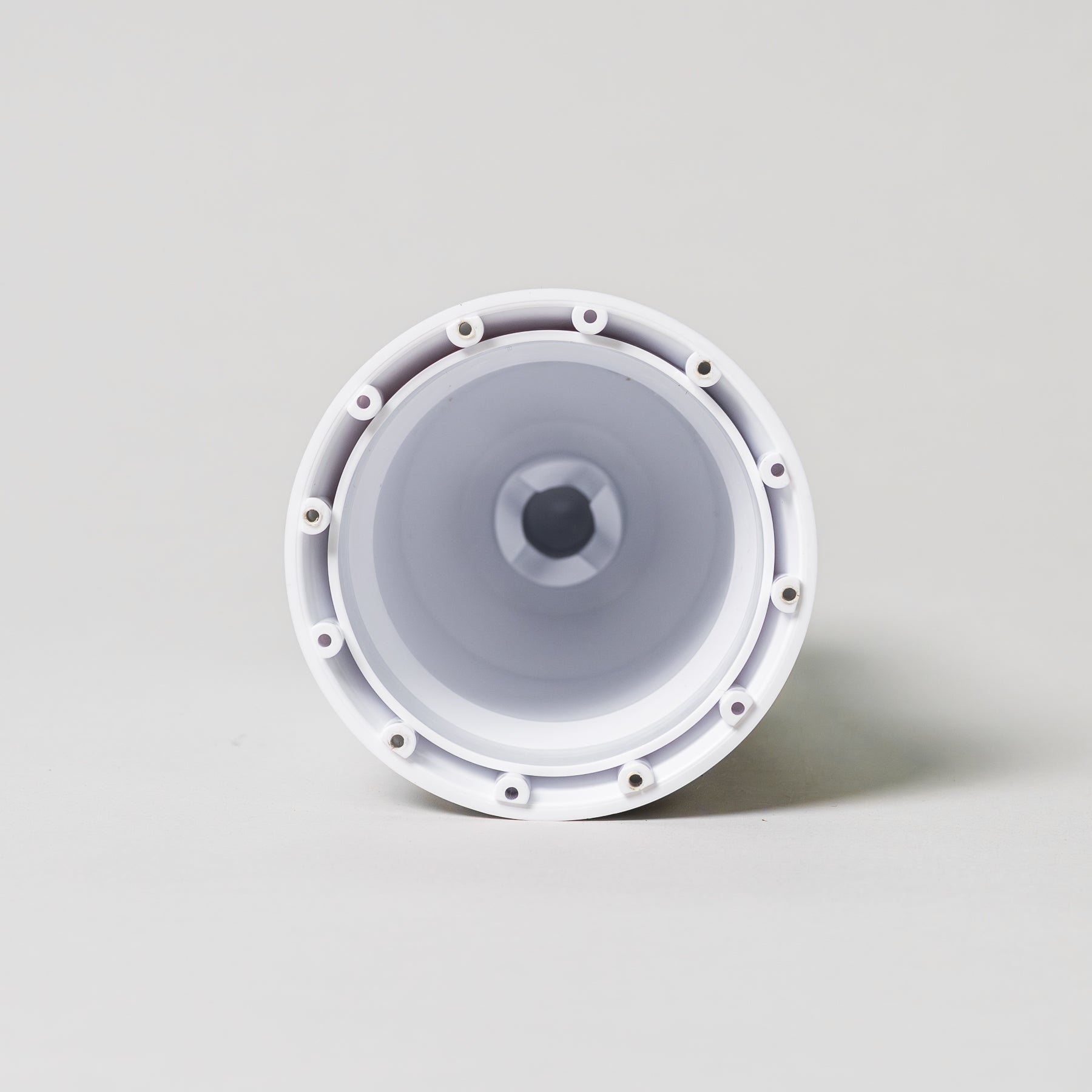 Center column for the NutriMill ice cream maker attachment laying down on a grey background