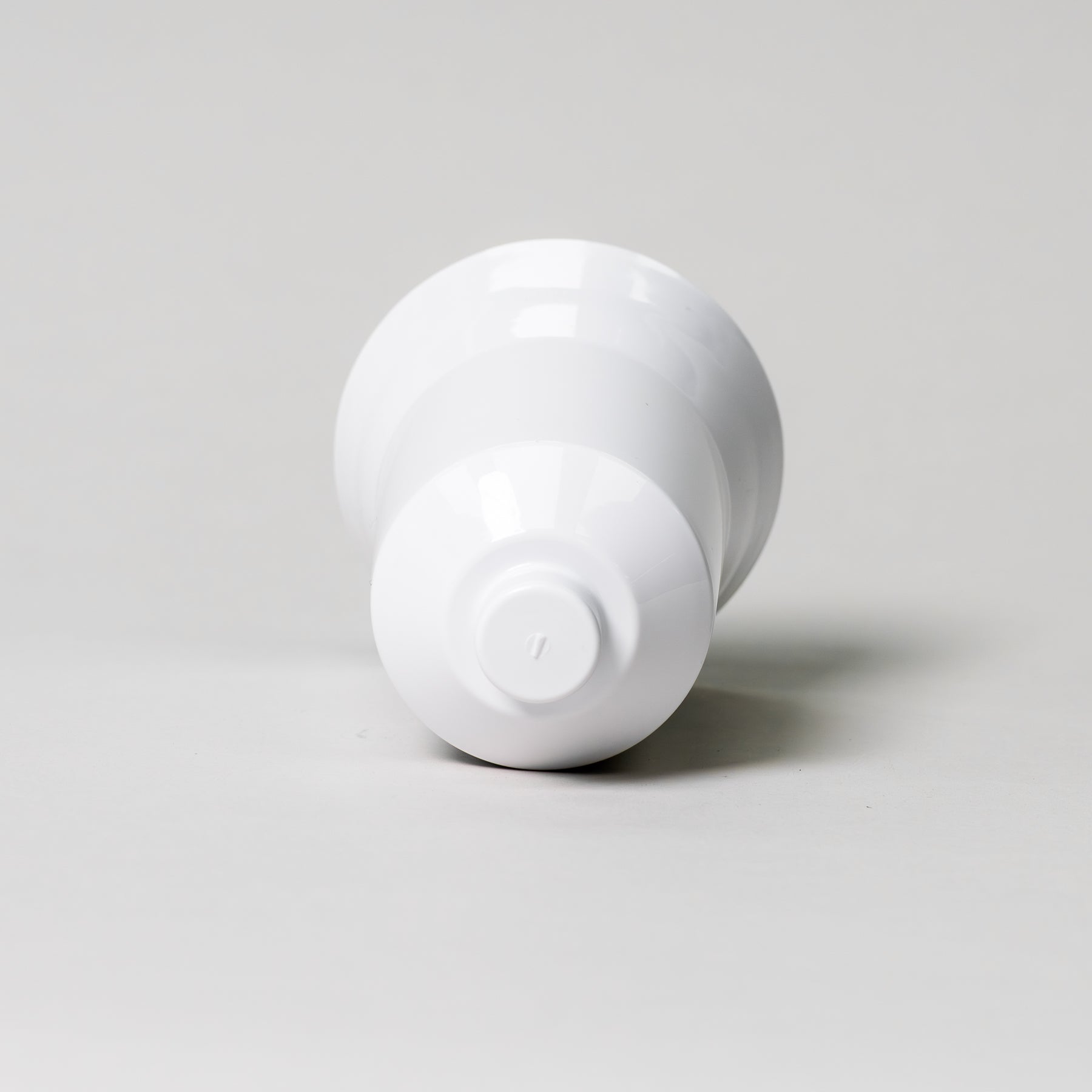 Center column for the NutriMill ice cream maker attachment laying down on a grey background