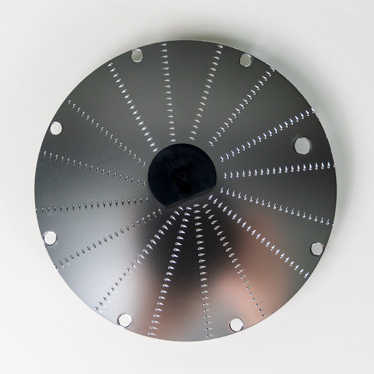 Magimix horseradish disk on a grey background