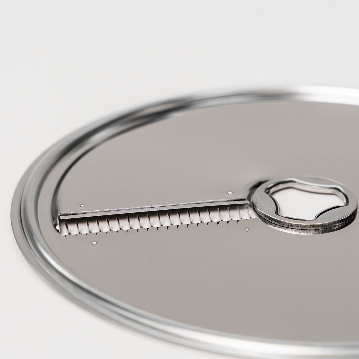 Close-up of the stainless steel julienne disk with its row of cutting teeth