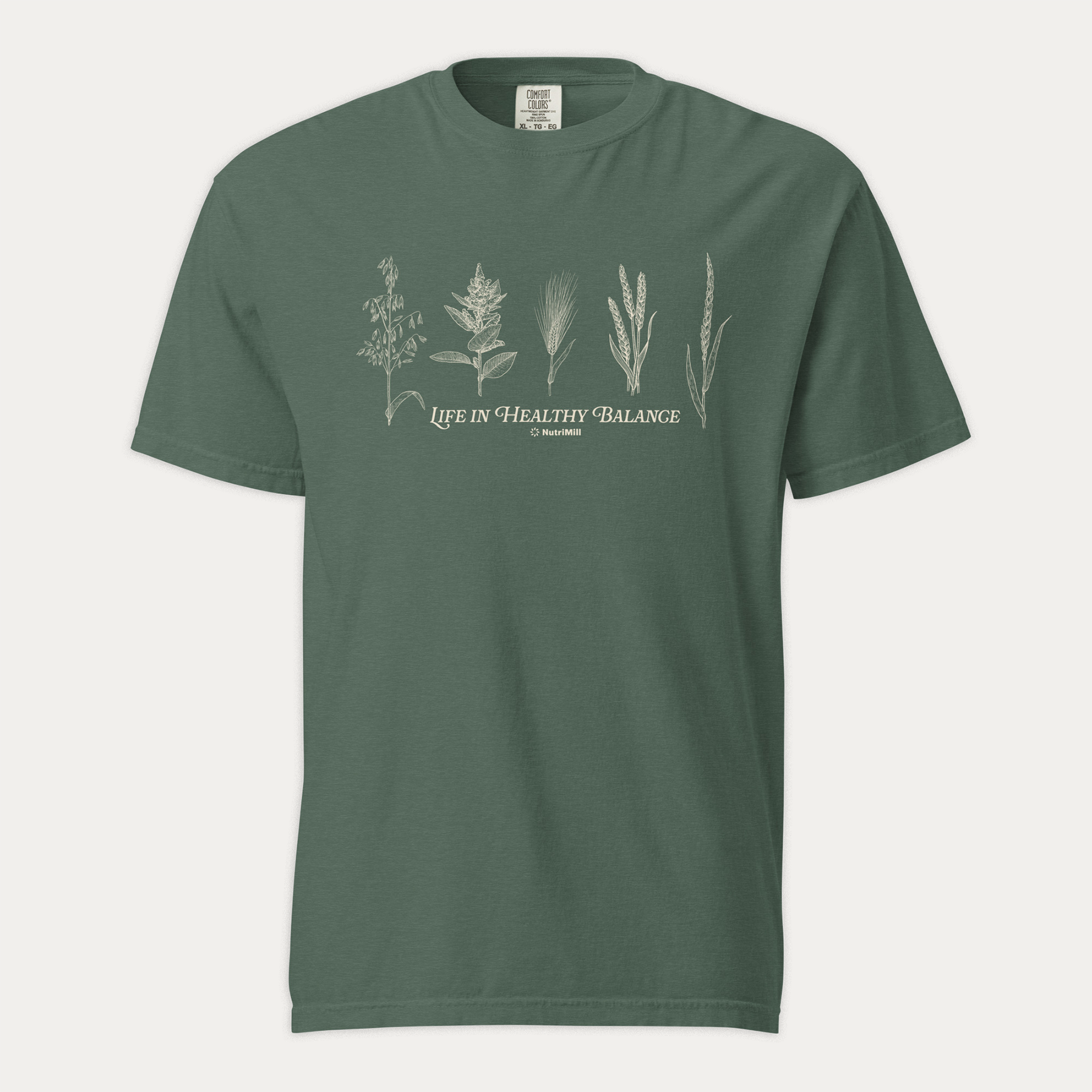 Front view of a blue spruce NutriMill 'Life in Healthy Balance' unisex garment-dyed heavyweight t-shirt with white wheat and grain illustrations