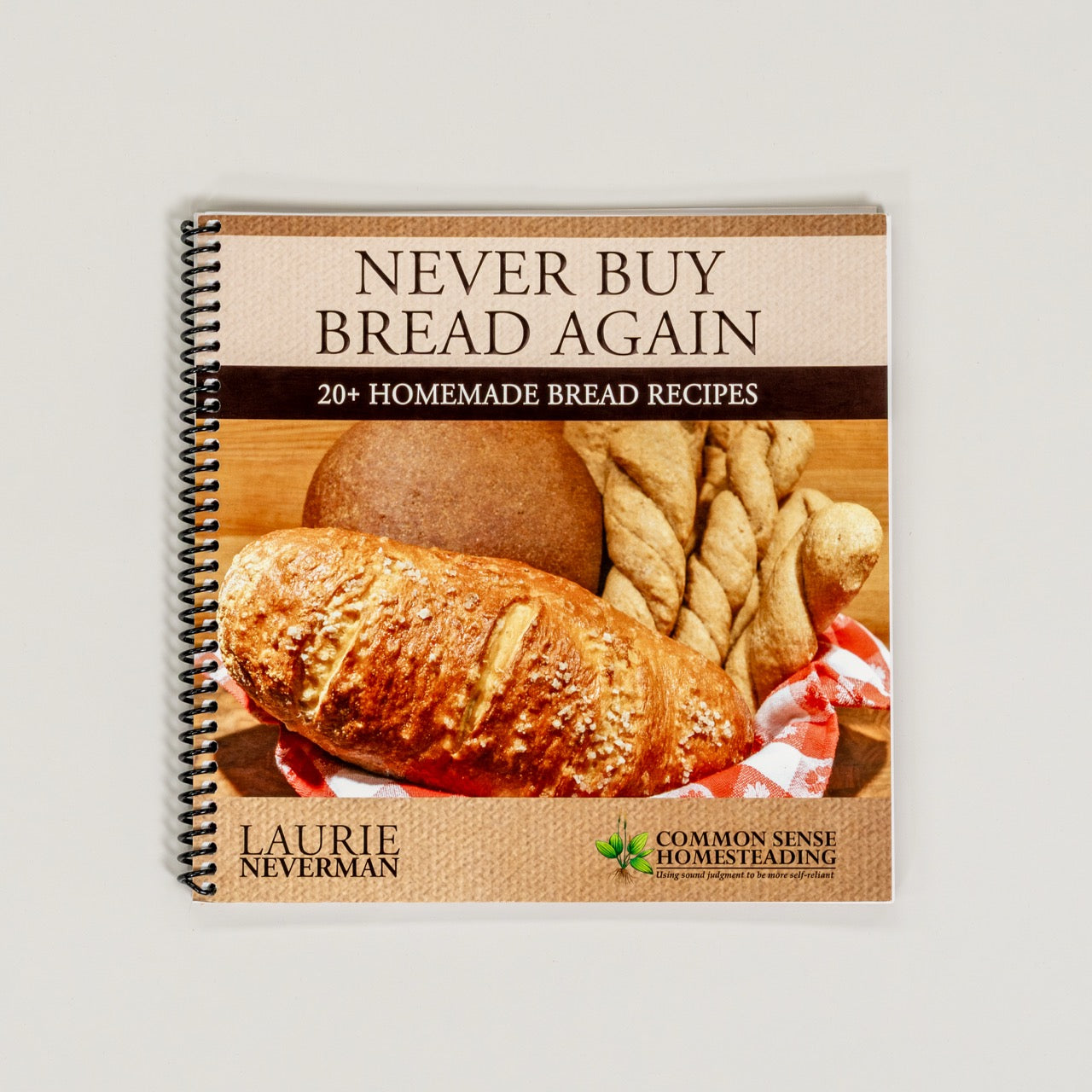 Cover of the book 'Never Buy Bread Again' featuring images of baked breads and the author's name, Laurie Neverman.