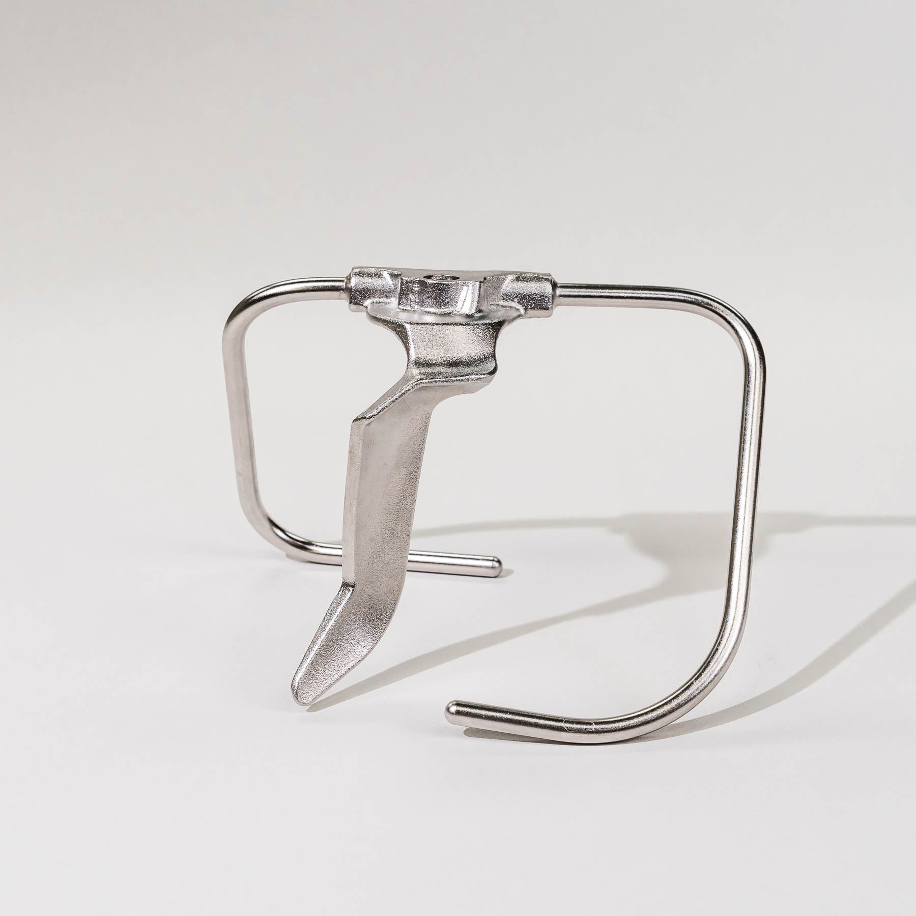 Stainless steel bottom drive dough hook attachment on a white background